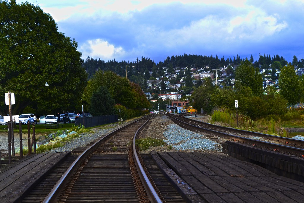 Railroad tracks leading toward a hillside town